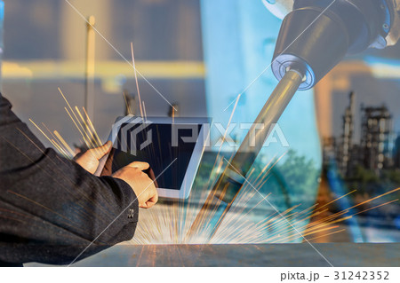 businessman is used tablet control robot welding businessman is used tablet control robot welding 31242352