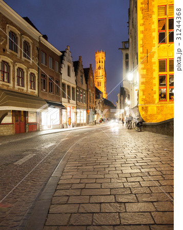Bruges by night. Cobbled street and illuminated Bruges by night. Cobbled street and illuminated 31244368