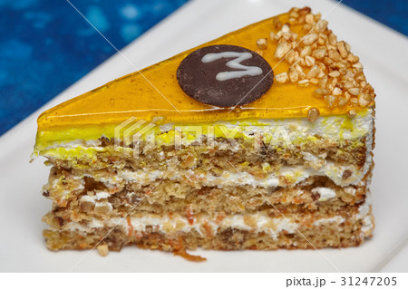 Piece of carrot cake with icing and walnut 31247205
