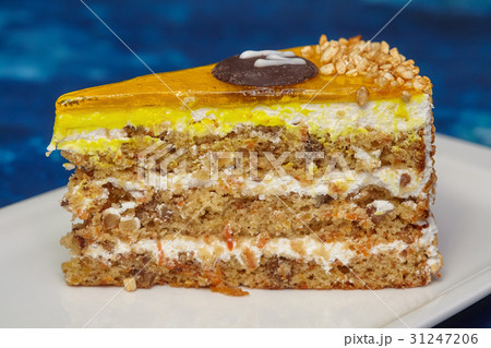 Piece of carrot cake with icing and walnut 31247206