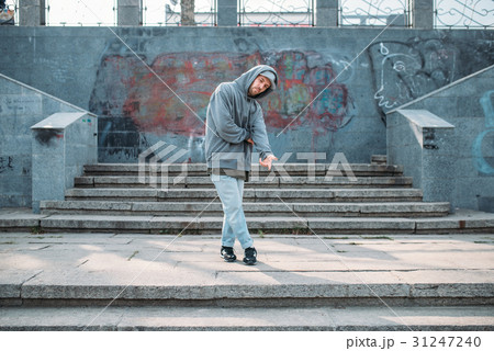 Male rapper posing on the street, urban dancing Male rapper posing on the street, urban dancing 31247240