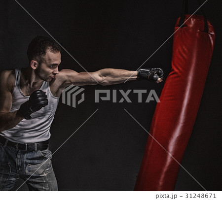 Boxing kick in the boxing bag Boxing kick in the boxing bag 31248671