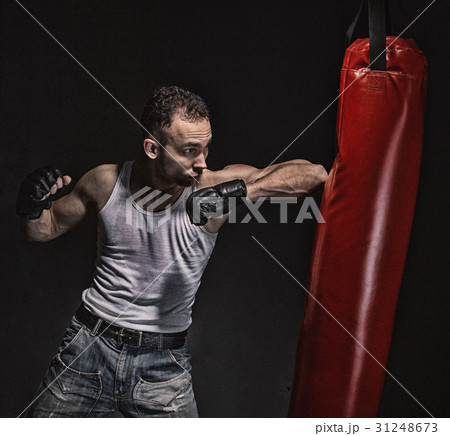 Boxing kick in the red punching pear Boxing kick in the red punching pear 31248673