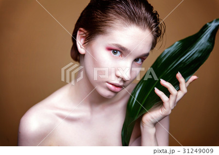Beautiful fresh woman's face with leaf Beautiful fresh woman's face with leaf 31249009