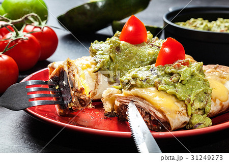 Mexican chimichanga with guacamole dip 31249273