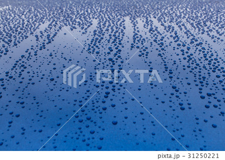 Drops of rain on a blue shiny smooth surface. Drops of rain on a blue shiny smooth surface. 31250221