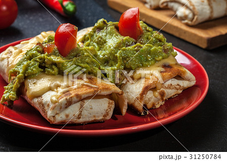 Mexican chimichanga with guacamole dip 31250784