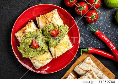 Mexican chimichanga with guacamole dip 31250788