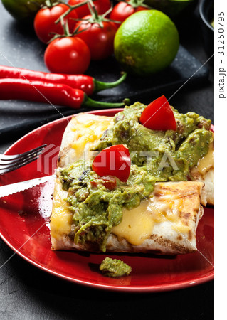 Mexican chimichanga with guacamole dip 31250795