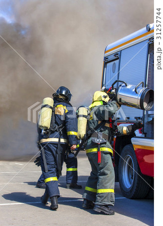 Team firefighters extinguish a fire  with the help 31257744
