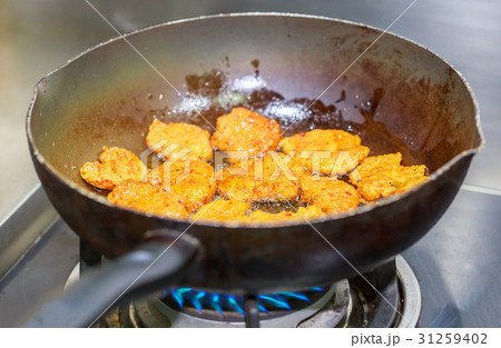Deep fried fish cake in the pan, on stove. 31259402