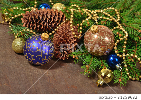 Christmas decorations and spruce branch and cones Christmas decorations and spruce branch and cones 31259632