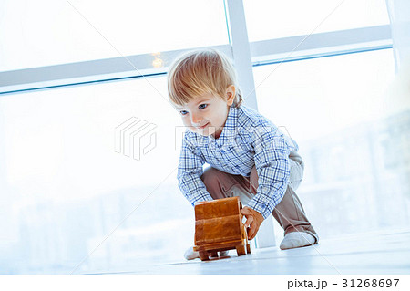 Boy rolls a toy car Boy rolls a toy car 31268697