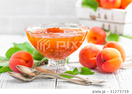 Apricot jam and fresh fruits with leaves 31273739