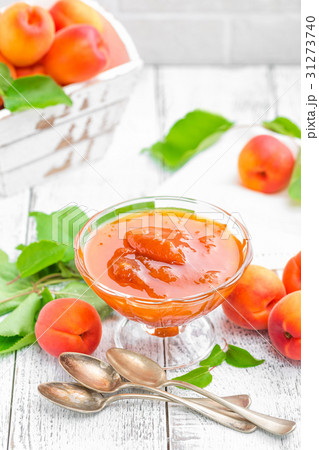 Apricot jam and fresh fruits with leaves 31273740