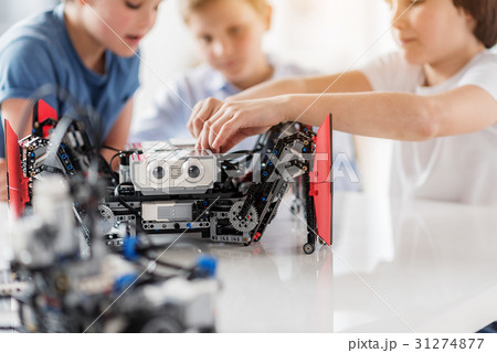 Busy interested children using robotics Busy interested children using robotics 31274877