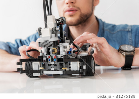 Busy man checking spare parts of toy 31275139