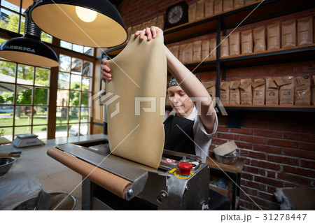 Female cook rolling dough 31278447