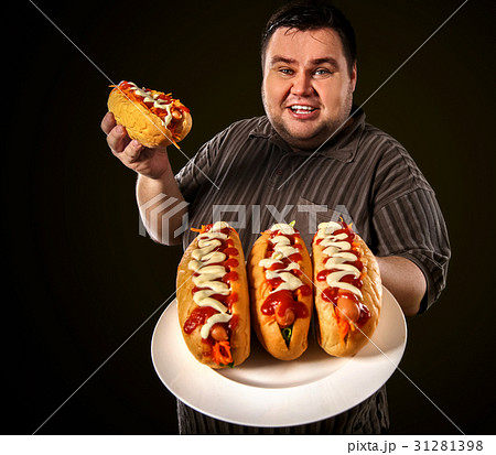 Fat man eating fast food hot dog. Breakfast for Fat man eating fast food hot dog. Breakfast for 31281398