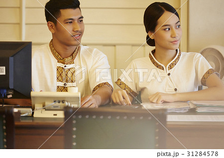 a portrait of two receptionists in reception desk. a portrait of two receptionists in reception desk. 31284578