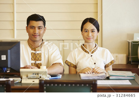 a portrait of male and female receptionists in reception. a portrait of male and female receptionists in reception. 31284665