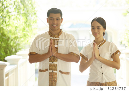 A photo of happy hotel staff welcoming in Thai style. A photo of happy hotel staff welcoming in Thai style. 31284737