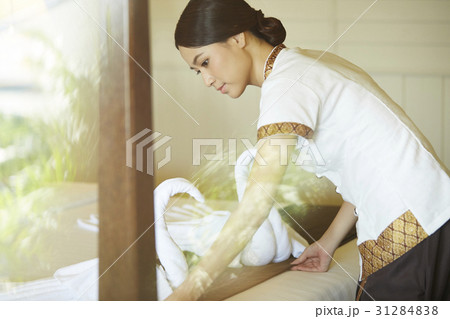 The waitress is preparing the bed in a room The waitress is preparing the bed in a room 31284838