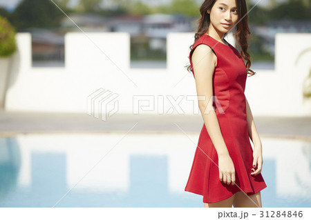 beautiful woman standing at poolside, vacation 31284846