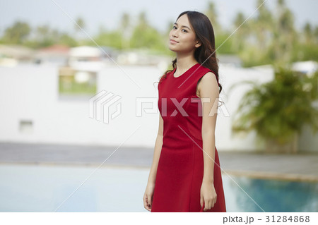 A photo a beautiful girl standing on poolside 31284868