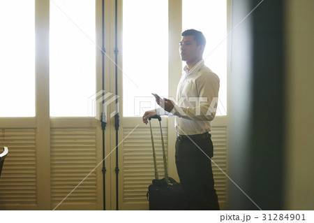 The man is holding the phone and thinking something 31284901