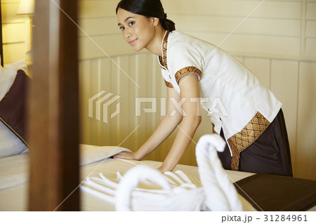 A photo of a housekeeper working in a hotel room. A photo of a housekeeper working in a hotel room. 31284961