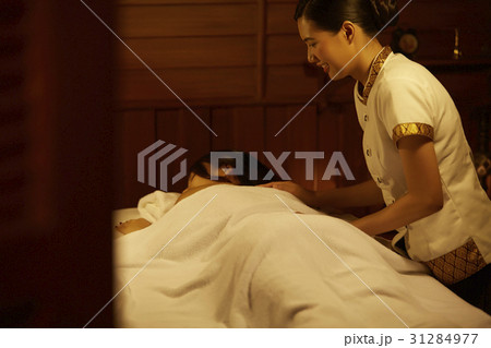 A young woman is getting a treatment from a massage therapist. A young woman is getting a treatment from a massage therapist. 31284977