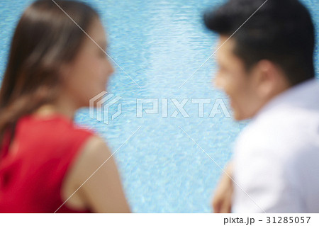a blurry photo of a couple looking together beside a pool a blurry photo of a couple looking together beside a pool 31285057