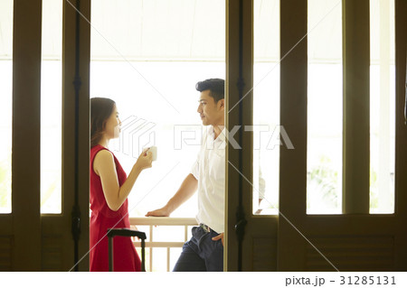 the couple is standing outside balcony and talking 31285131
