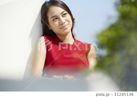 the beautiful young girl is looking at something outdoor. the beautiful young girl is looking at something outdoor. 31285136