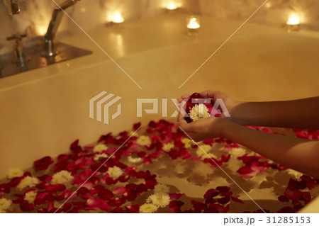 someone is holding flowers and putting into a bathtub someone is holding flowers and putting into a bathtub 31285153