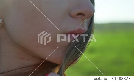Girl lips. Girl is standing on the nature hair Girl lips. Girl is standing on the nature hair 31288823