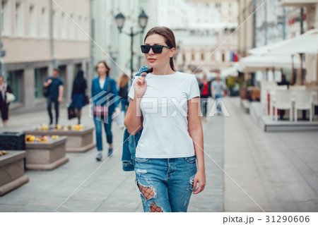 Attractive girl in sunglasses walking along the 31290606