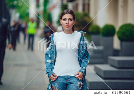 Attractive girl in a jeans jacket and white t 31290661