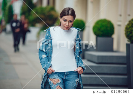 Attractive girl in a jeans jacket and white t 31290662