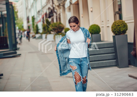 Attractive girl in a jeans jacket and white t 31290663