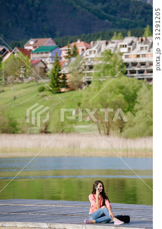 woman with smartphone backpacking in mountains 31291205