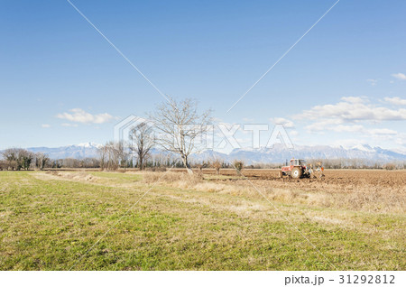 Agricultural landscape with tractor plowing. 31292812