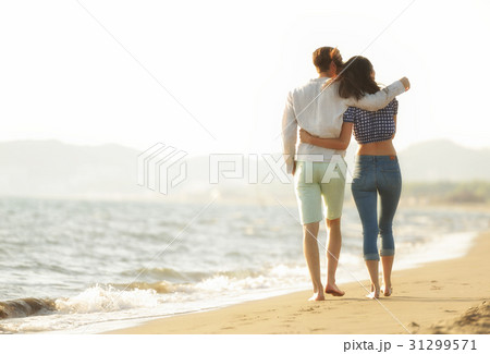 happy couple waling on the beach and having fun happy couple waling on the beach and having fun 31299571