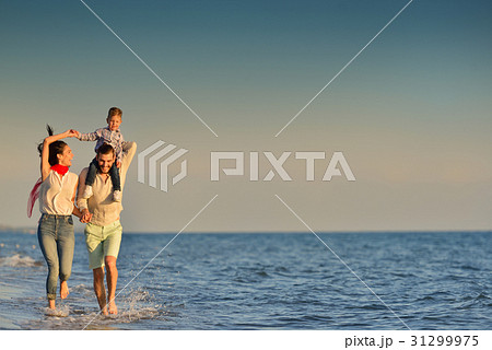 happy young family have fun on beach run and jump happy young family have fun on beach run and jump 31299975