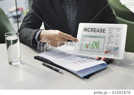 Hands working on digital device network graphic overlay 31302876