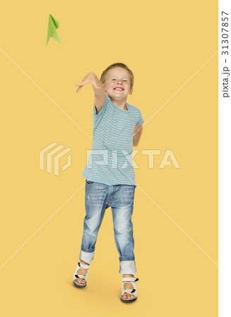 Happiness little boy smiling and flying paper airplane studio portrait 31307857