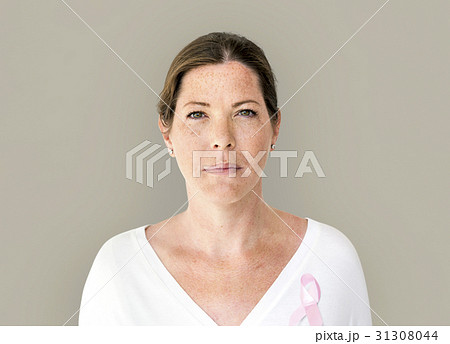 Woman with pink ribbon for breast cancer awareness charity studio portrait Woman with pink ribbon for breast cancer awareness charity studio portrait 31308044