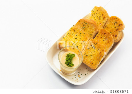 Garlic bread and herb bread slice on dish. 31308671