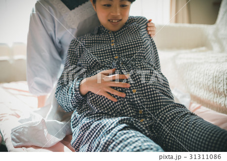 woman during pregnancy or shortly after childbirth 31311086